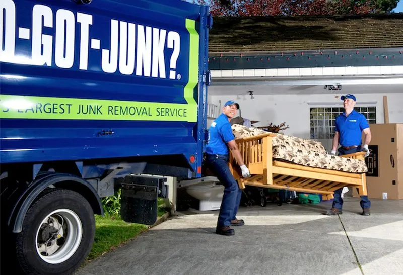 1-800-GOT-JUNK? crew removing furniture from a home