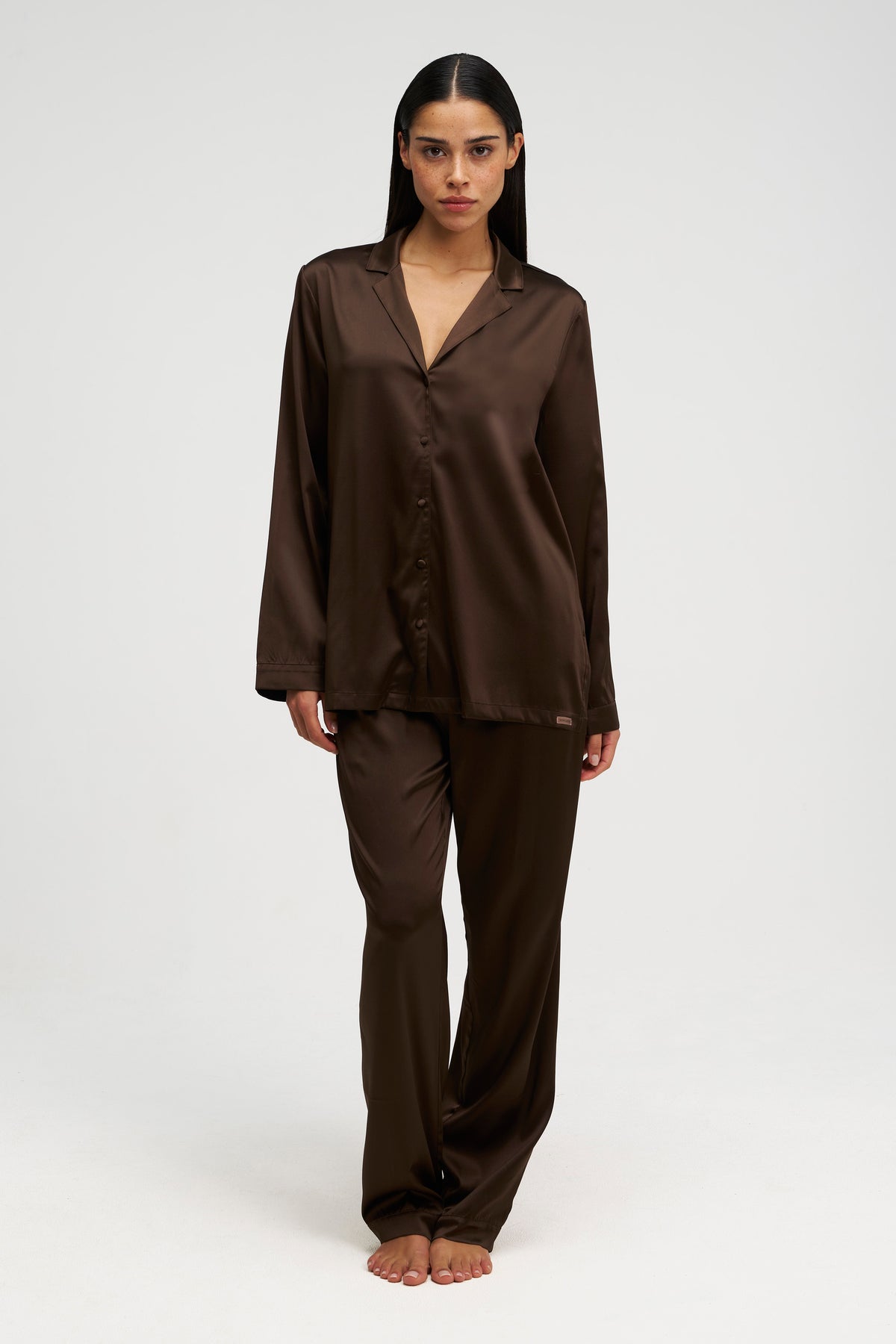 Woman wearing a brown Dore and Rose silk pajama set